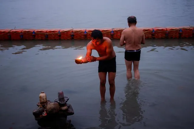 Hindu devotees pray on the banks of the Sarayu river before the inauguration of the Hindu Lord Ram temple in Ayodhya in India on January 22, 2024. (Photo by Adnan Abidi/Reuters)