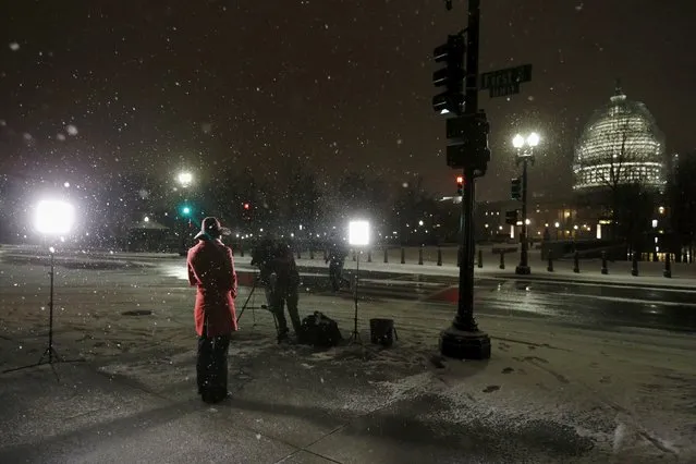A television reporter prepares to go on the air in the snow near the U.S. Capitol in Washington January 20, 2016. (Photo by Jonathan Ernst/Reuters)