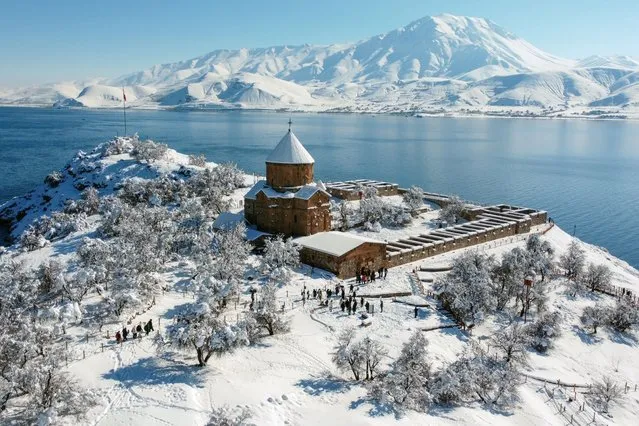 A view of Cathedral of the Holy Cross, covered with snow, on Akdamar Island, one of the most visited places by local and foreign tourists, after snowfall in Gevas district of Van, Turkiye on January 25, 2024. (Photo by Ozkan Bilgin/Anadolu via Getty Images)