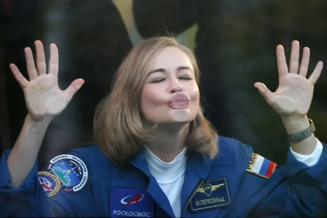 ISS Expedition 66 main crew member, actress Yulia Peresild blows a kiss through a bus window as she leaves for the Baikonur Cosmodrome in Kazakhstan on October 5, 2021. The launch of the Soyuz MS-19 mission to be involved in making the feature film “The Challenge” (working title) aboard the International Space Station is scheduled for 5 October 2021 at 11:55 Moscow time from the Baikonur Cosmodrome. ISS Expedition 66 main crew members include Roscosmos cosmonaut Anton Shkaplerov, actress Yulia Peresild, and filmmaker Klim Shipenko. The film is a joint project of Roscosmos and Channel One. (Photo by Sergei Savostyanov/TASS)