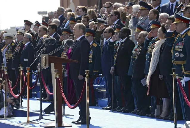 Russia's President Vladimir Putin (C) observes a minute of silence during the Victory Day parade at Red Square in Moscow, Russia, May 9, 2015. (Photo by Reuters/Host Photo Agency/RIA Novosti)