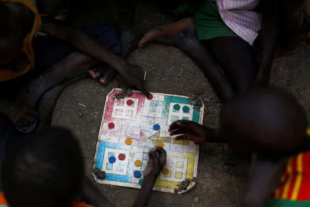 Children play a board game in the United Nations Mission in South Sudan (UNMISS) Protection of Civilian site (CoP), near Bentiu, northern South Sudan, February 9, 2017. (Photo by Siegfried Modola/Reuters)