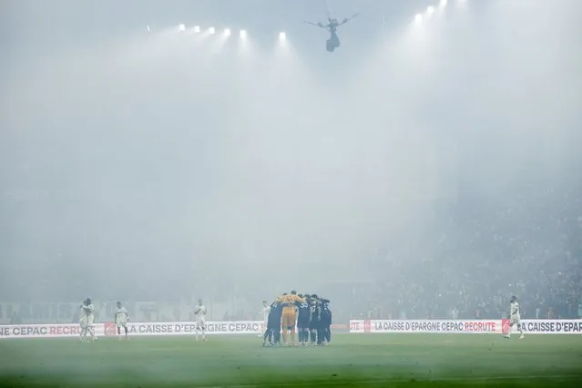 PSG players huddle in the fog prior the French Ligue 1 soccer match between Olympique Marseille and Paris Saint-Germain, in Marseille, France, 31 March 2024. (Photo by Guillaume Horcajuelo/EPA)