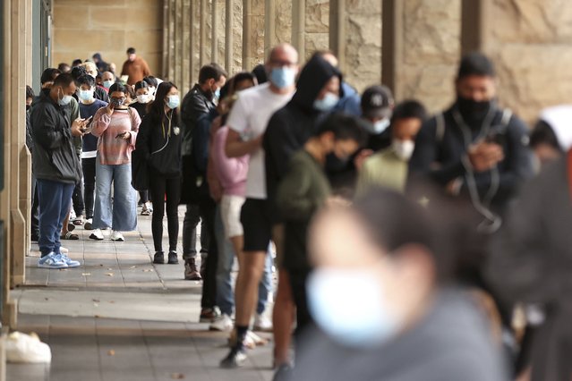 Members of the public queue to take a COVID-19 tests in Sydney, Tuesday, December 28, 2021. Australia's Victoria and Queensland states reported record levels of new daily coronavirus infections on Tuesday as pressure on testing centers prompted calls for wider use of rapid antigen tests. (Photo by Brendon Thorne/AAP Image via AP Photo)