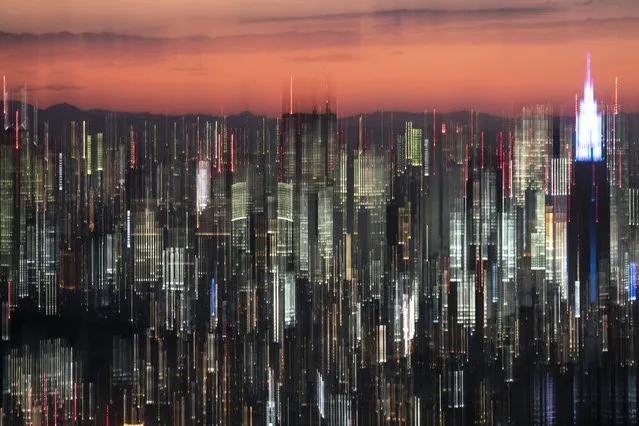 In this panned photo, Tokyo's skyline is seen at dusk from the Roppongi Hills Mori Tower Monday, June 17, 2019, in Tokyo. (Photo by Jae C. Hong/AP Photo)