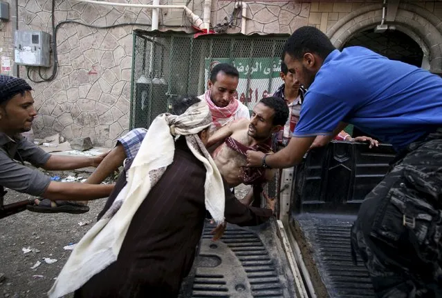 A fighter of the Popular Resistance Committee is being rushed to a hospital after he was injured during clashes with Houthi fighters in Yemen's southwestern city of Taiz May 11, 2015. (Photo by Reuters/Stringer)