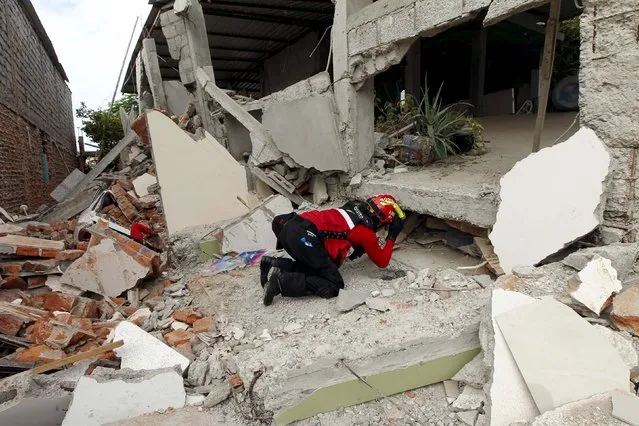 A fireman works after an earthquake struck off Ecuador's Pacific coast, at Tarqui neighborhood in Manta April 17, 2016. (Photo by Guillermo Granja/Reuters)