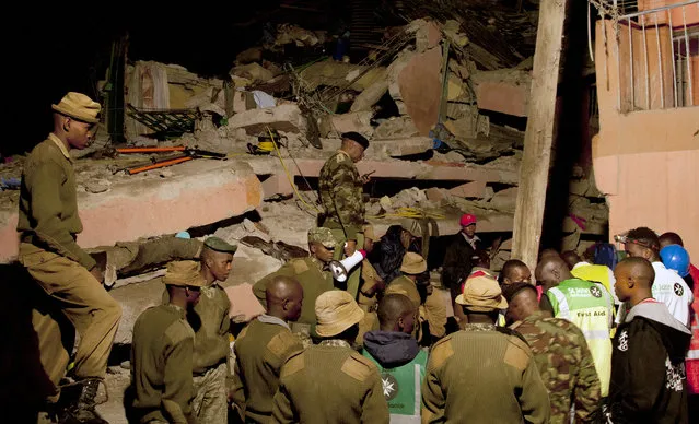 Kenyan National Youth Servicemen work at the site of a building collapse in Nairobi, Kenya, Saturday, April 30, 2016. (Photo by Sayyid Abdul Azim/AP Photo)