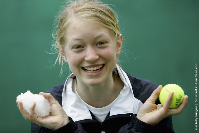 Ball-girl Gianna Kuehn holds a snowball after a thunderstorm during the Masters Series Hamburg at Rothenbaum