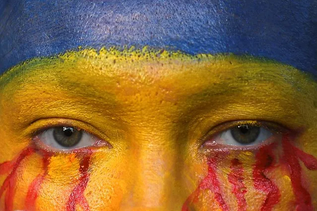 Lidiya Zhuravlyova, a Ukraine-born performance artist, looks on as she takes part in an anti-war protest, after Russia launched a massive military operation against Ukraine, in Bangkok, Thailand on February 27, 2022. (Photo by Chalinee Thirasupa/Reuters)