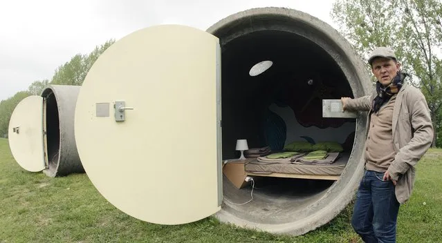 Andreas Strauss poses at “Dasparkhotel” hotel rooms in a public park in the Upper Austrian town of Ottensheim April 29, 2014. The rooms are constructed from repurposed concrete drain pipes and can be booked anonymously on the internet. Owner Strauss says the hotel is a hospitality project on a “pay as you wish” basis, a system where customers pay what they can afford. The hotel is open from May 1 till October 1. (Photo by Heinz-Peter Bader/Reuters)