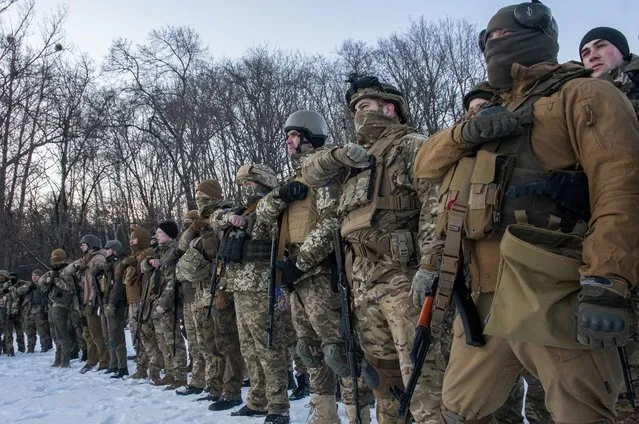 Ukrainian servicemen gesture during a training session outside Kharkiv, Ukraine, Friday, March 11, 2022. (Photo by Andrew Marienko/AP Photo)