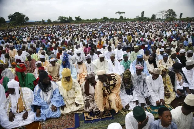 Muslims pray during Eid-al-Fitr prayers in an open field, marking the end of the holy month of Ramadan, in Lagos July 17, 2015. (Photo by Akintunde Akinleye/Reuters)