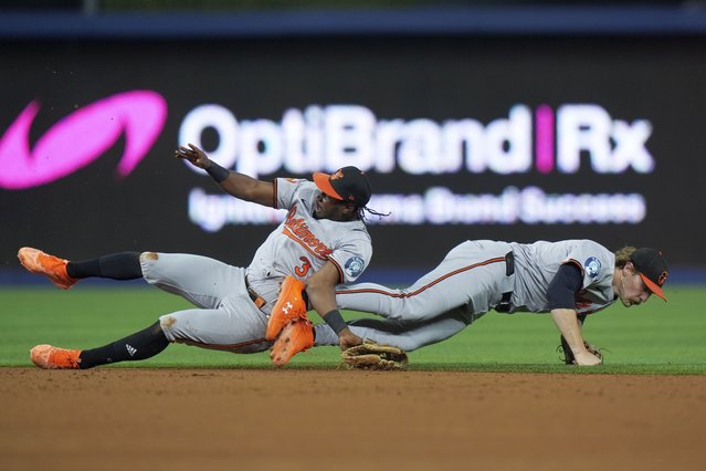 Baltimore Orioles second baseman Jorge Mateo, left, and shortstop Gunnar Henderson collide as they vie for a ball hit by Miami Marlins' Jesús Sánchez during the third inning of a baseball game, Tuesday, July 23, 2024, in Miami. Mateo was helped off the field after the play. (Photo by Wilfredo Lee/AP Photo)