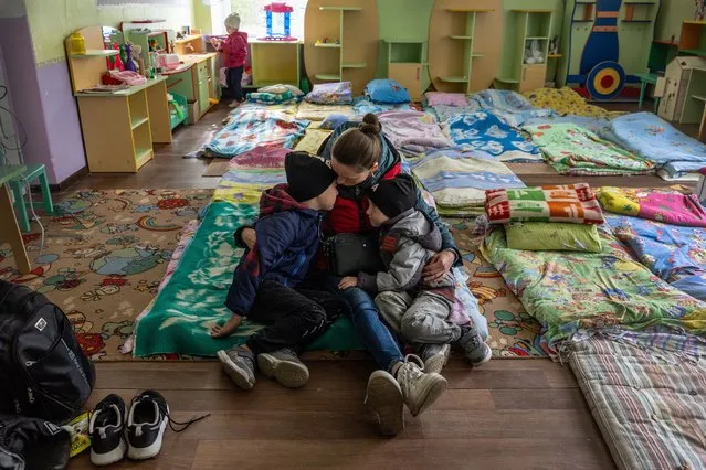 Svitlana, 36, holds her sons Artem, 7, and Kyrylo, 5, while taking shelter in a kindergarten on May 04, 2022 in Kryvyi Rih, Ukraine. They had escaped the frontline village of Kyselivka, now under Russian control, in Ukraine's southern Kherson region. Her husband and the boys' father was already working abroad before the war and will meet them in Poland. The Ukrainian city and district of Kryvyi Rih, known as an industrial center and the hometown of President Volodymyr Zelensky, lies less than 70km north of Russian-occupied areas in nearby Kherson Oblast, where invading Russian forces have sought to create a land bridge between the Crimean peninsula and the eastern Donbas region. (Photo by John Moore/Getty Images)