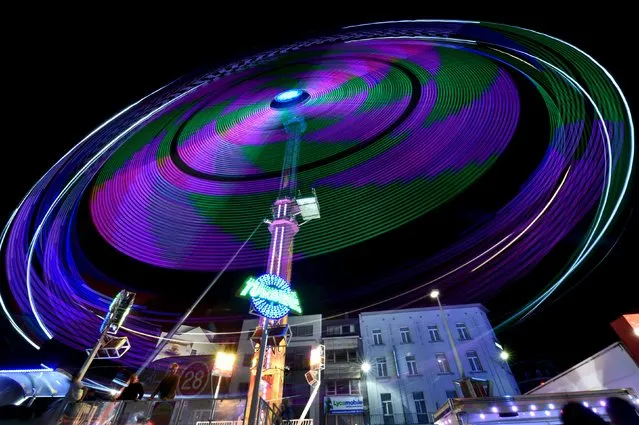 An amusement ride is seen at the Midi Fair, one of the oldest summer events in Brussels, Belgium, in the early hours of August 1, 2015. (Photo by Eric Vidal/Reuters)