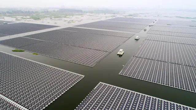 Photo taken on June 22, 2017 shows the PV power station, also known as a solar park floating on waters of the coal mining subsidence area in Huainan City, east China's Anhui Province. (Photo by Guo Chen/Xinhua/Barcroft Images)