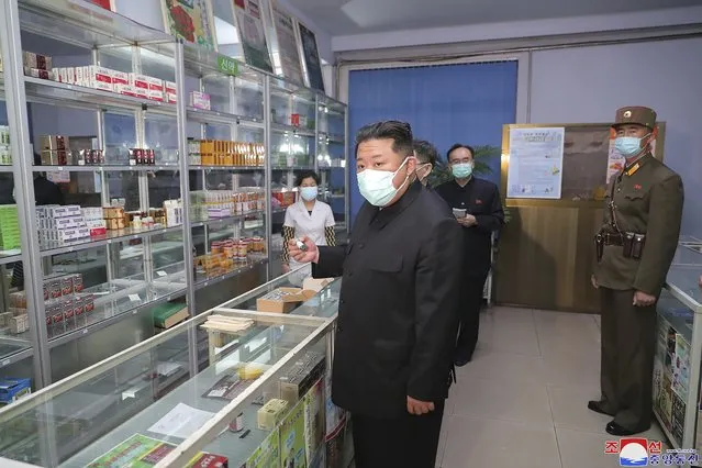 In this photo provided by the North Korean government, North Korean leader Kim Jong Un, center, visits a pharmacy in Pyongyang, North Korea Sunday, May 15, 2022. Independent journalists were not given access to cover the event depicted in this image distributed by the North Korean government. The content of this image is as provided and cannot be independently verified.   Korean language watermark on image as provided by source reads: “KCNA” which is the abbreviation for Korean Central News Agency. (Photo by Korean Central News Agency/Korea News Service via AP Photo)