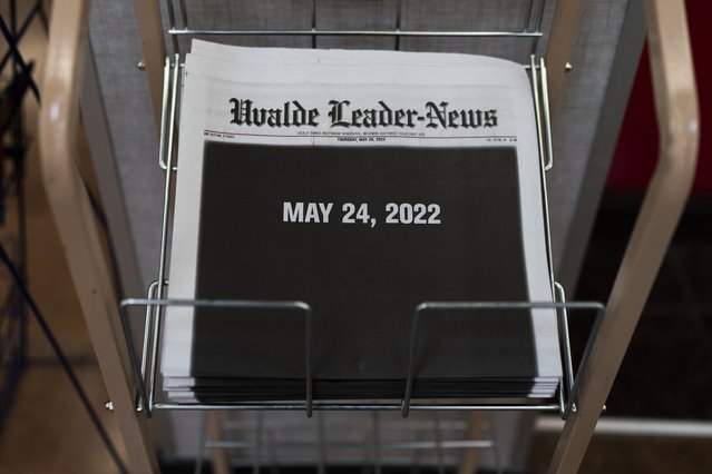 Copies of the Uvalde Leader-News with a black front page showing the date of the Robb Elementary School shooting are seen at a market in Uvalde, Texas, Thursday, May 26, 2022. Law enforcement authorities in Texas are facing questions and criticism over how much time elapsed before they stormed an Uvalde elementary school classroom and put a stop to the rampage by a gunman who killed 19 children and two teachers. (Photo by Jae C. Hong/AP Photo)