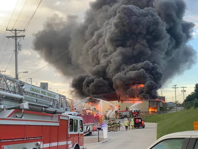 Firefighters work to extinguish a fire as smoke billows at a chemical plant in Omaha, Nebraska U.S. May 30, 2022 in this picture obtained from social media. Picture taken May 30, 2022. (Photo by Omaha Fire Department/Facebook via Reuters)