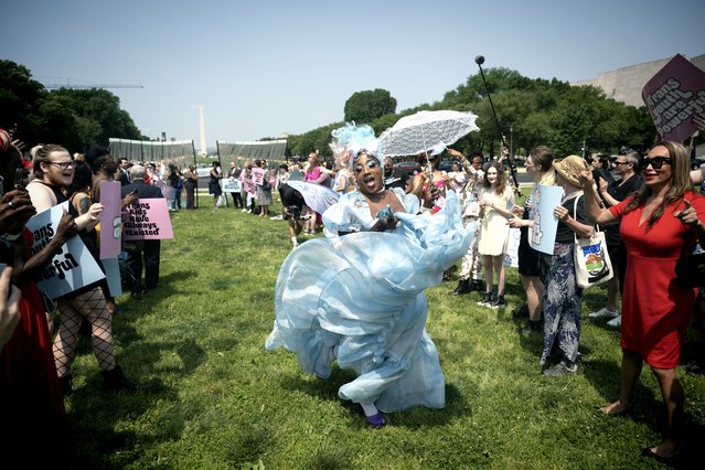 Adult drag performer Stormie Daie takes a moment to sashay in her baby blue dress for spectators attending the Trans Youth Prom on the National Mall in Washington, DC on May 22, 2023. (Photo by Marvin Joseph/The Washington Post)