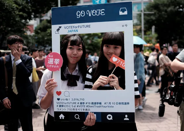 High school students pose for photos with a cardboard Instagram frame calling on youths to vote in the July 10 upper house election, in front of a busy crossing in Shibuya district in Tokyo, Japan June 26, 2016. (Photo by Toru Hanai/Reuters)