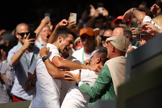 Novak Djokovic of Serbia celebrates victory with his team in the stands against Nick Kyrgios of Australia during their Men's Singles Final match on day fourteen of The Championships Wimbledon 2022 at All England Lawn Tennis and Croquet Club on July 10, 2022 in London, England. (Photo by Julian Finney/Getty Images)