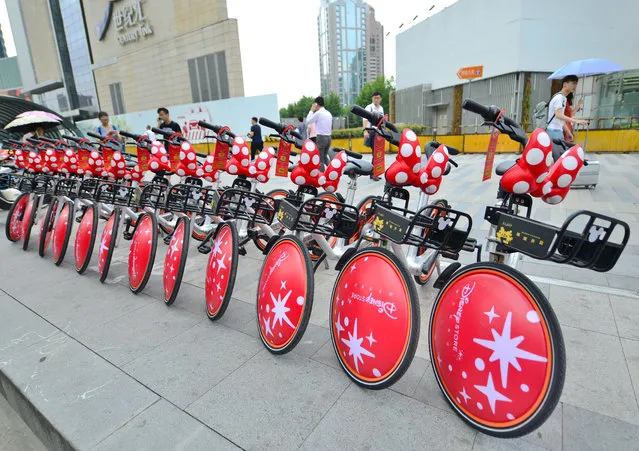 Minnie Mouse-themed bicycles line a road in the city as part of a Disney/Mobike bike-sharing venture in Shanghai, China on Agust 17, 2017. (Photo by Imaginechina/Rex Features/Shutterstock)