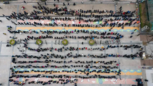 A photo taken with a drone shows South Korean people queuing to purchase masks outside a Happy Department store in Seoul, South Korea, 28 February 2020. According to the Korea Center for Disease Control and Prevention (KCDC), 13 people in South Korea have died from the COVID-19 with the nation's total infections reported to be over 2,000. (Photo by Jeon Heon-Kyun/EPA/EFE)