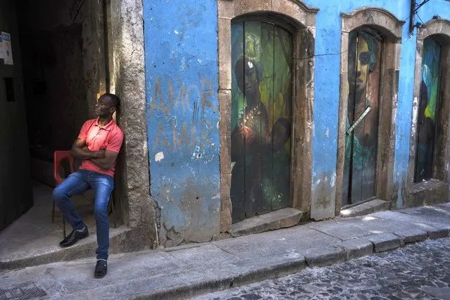 A man leans against a door frame in the Pelourinho neighborhood of Salvador, Bahia State, Brazil, Wednesday, September 14, 2022. (Photo by Rodrigo Abd/AP Photo)