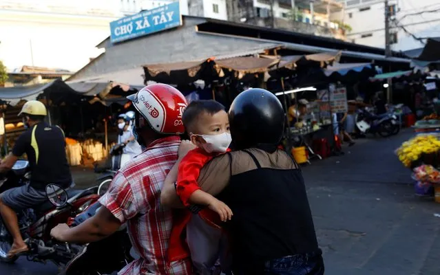 A boy wearing a protective mask rides a motorbike with his family during the outbreak of the coronavirus disease (COVID-19), in Ho Chi Minh, Vietnam, April 18, 2020. (Photo by Yen Duong/Reuters)