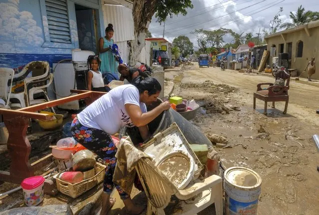 Residents work to recover belongings from flooding caused by Hurricane Fiona in the Los Sotos neighborhood of Higuey, Dominican Republic, Tuesday, September 20, 2022. (Photo by Ricardo Hernandez/AP Photo)