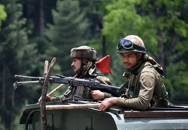 Indian army soldiers on top a military vehilce move along the Srinagar-Leh National highway on June 17, 2020.At least 20 Indian soldiers were killed in a violent clash with Chinese forces in a disputed border area. (Photo by Faisal Khan/Anadolu Agency via Getty Images)