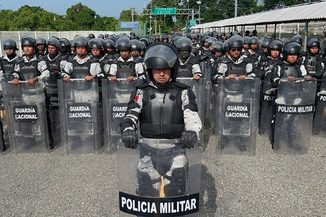 Members of the Mexican National Guard stand on the border between Mexico and Guatemala during a joint operation with Guatemalan authorities and Army to prevent the crossing of migrant caravans in Ciudad Hidalgo, Chiapas state, Mexico, on October 21, 2022. (Photo by AFP Photo/Stringer)
