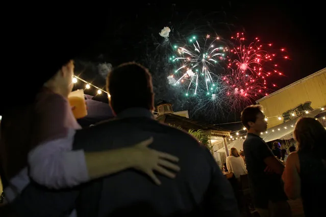 People watch the annual fireworks display during a visit by U.S. President Barack Obama and his family in Oak Bluffs, Massachusetts, U.S., August 19, 2016. (Photo by Joshua Roberts/Reuters)
