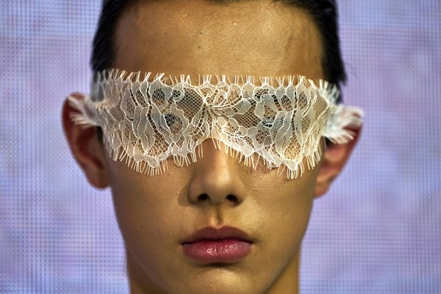 A model wears the latest fashion from Huqiu Bridal City during China Fashion Week in Beijing, Friday, March 21, 2025. (Photo by Ng Han Guan/AP Photo)