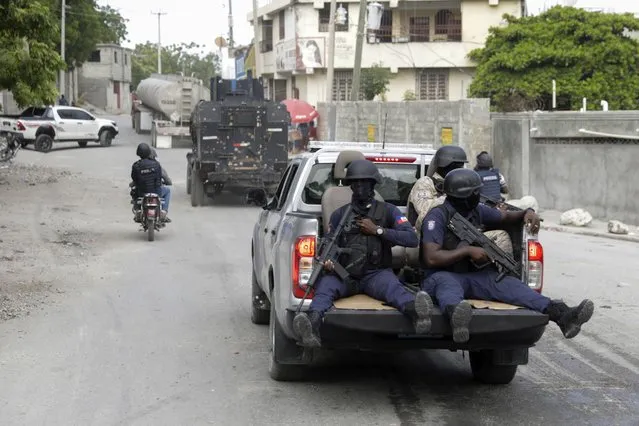 A police convoy escort fuel trucks filled with gas as they drive from the Varreux fuel terminal, in Port-au-Prince, Haiti, Tuesday, November 8, 2022. (Photo by Joseph Odelyn/AP Photo)