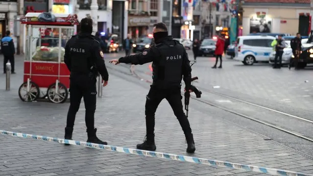 Turkish policemen try to secure the area after an explosion at Istiklal Street, in Istanbul, Turkey 13 November 2022. According to governor Ali Yerlikaya, an explosion that occurred at roughly 4.20 p.m. local time has resulted in losses and injuries. Emergency personnel were dispatched to the incident. (Photo by Erdem Sahin/EPA/EFE)