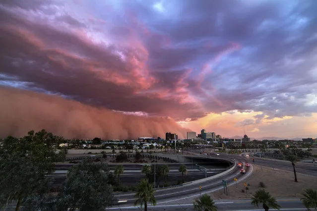 A gorgeous dust storm and low level clouds roll into downtown Phoenix, Ariz., on July 3, 2014. (Photo by Mike Olbinski/Caters News Agency)