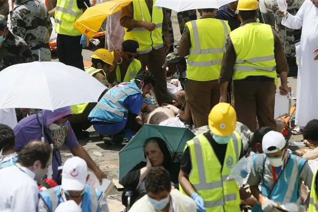 Rescue workers attend to victims of a stampede in Mina, Saudi Arabia during the annual hajj pilgrimage on Thursday, September 24, 2015. (Photo by AP Photo)