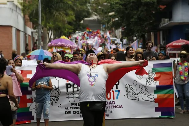 In this September 30, 2017 photo, members of a gay organization “Panambi”, meaning butterfly in Guarani, protest the killing of transvestite prostitutes and demand equal rights for gays during the annual LGBQT parade in Asuncion, Paraguay. Discrimination against gay and transgender people has traditionally been the norm in Paraguay, and activists say it's becoming more evident since the conservative government recently banned the teaching of sexual diversity in schools. (Photo by Jorge Saenz/AP Photo)