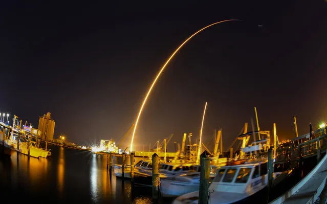 This time exposure photo taken with a fisheye lens shows a SpaceX Falcon 9 rocket, with a payload including two lunar rovers from Japan and the United Arab Emirates, launching from Launch Complex 40 at the Cape Canaveral Space Force Station in Cape Canaveral, Fla., Sunday, December 11, 2022, as seen from the deck of Grills Seafood Deck at Port Canaveral. (Photo by Malcolm Denemark/Florida Today via AP Photo)