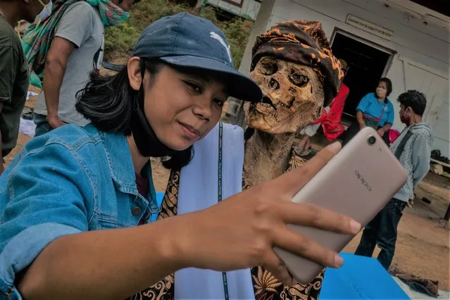 Iin Arensia taking a selfie with his grandfather preserved body Ne Potta during a traditional ritual called “Manene” in Panggala, Nort Toraja, South Sulawesi, Indonesia, Tuesday, August 25th 2020. (Photo by Hariandi Hafid/ZUMA Wire/Rex Features/Shutterstock)