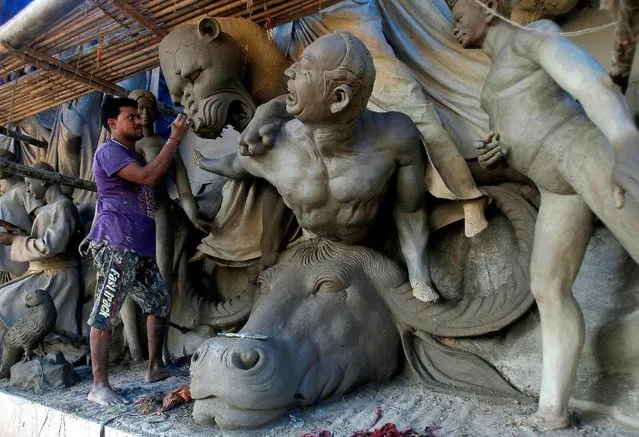 An artist makes clay idols at a pandal, or a temporary platform, ahead of the Durga Puja festival, in Agartala, India September 12, 2016. (Photo by Jayanta Dey/Reuters)