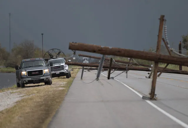 People trying to reach their homes in Cameron parish drive past downed power lines after the passing of Hurricane Laura south of Lake Charles, Louisiana on August 28, 2020. At least six people were killed by Hurricane Laura in Louisiana and search teams may find more victims, but the governor said on August 27 that the most powerful storm to make landfall in the US state in living memory did not cause the “catastrophic” damage that had been feared. (Photo by Andrew Caballero-Reynolds/AFP Photo)