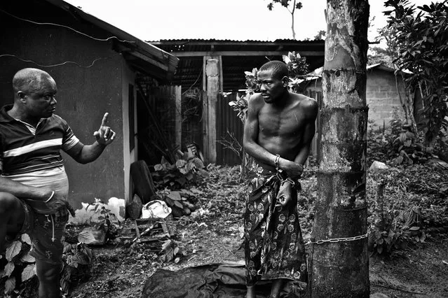 “Native Doctor Lekwe Deezia claims to heal mental illness through the power of prayer and traditional herbal medicines. While receiving treatment, which can sometimes take months, his patients are chained to trees in his courtyard. They are not given shelter or protection from the elements. One patient tells the photographer they are sometimes beaten for no reason. The Niger Delta, Nigeria, October 2012”. (Photo and comment by Robin Hammond, New Zealand/2013 Sony World Photography Awards