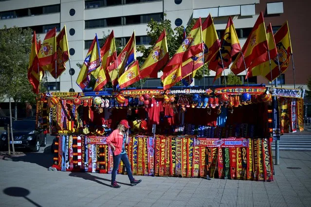 A woman walks in front of a kiosk selling football scarves and Spanish flags before Spain-Luxembourg Euro 2016 Group C qualification soccer match in Logrono, Spain October 9, 2015. (Photo by Vincent West/Reuters)