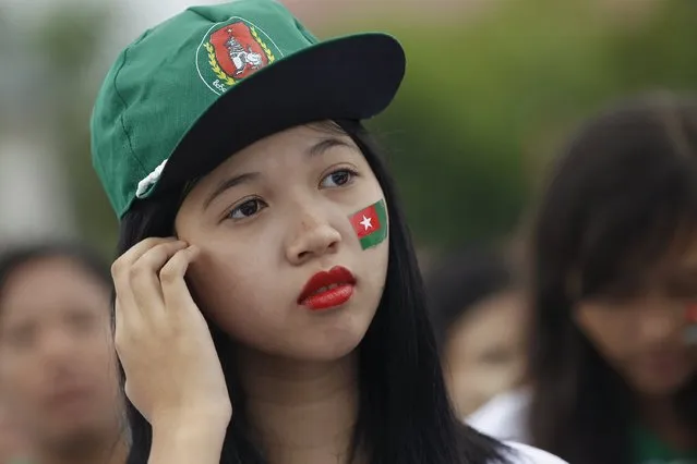 A supporter is seen with a USDP flag sticker during Myanmar's ruling Union Solidarity and Development Party (USDP) campaign rally in Yangon, Myanmar October 10, 2015. (Photo by Soe Zeya Tun/Reuters)