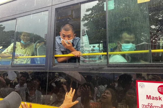 A man looks out from a bus window as people look for their family members and relatives on a bus carrying prisoners who released from Insein Prison Thursday, November 17, 2022, in Yangon, 2022, in Yangon, Myanmar. The country's military-controlled government announced Thursday it was releasing and deporting an Australian academic, a Japanese filmmaker, an ex-British diplomat and an American as part of a broad prisoner amnesty to mark the country’s National Victory Day. (Photo by AP Photo/Stringer)
