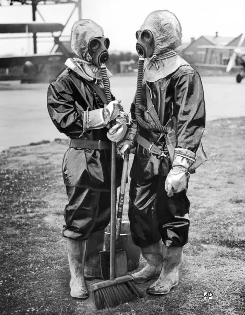 Navy, Army and Air Force are combining in coastal defense exercises which continued over a wide area of sea and land between Portsmouth and Plymouth, Devon. Among the innovations used, when an air raid black-out plunged Portsmouth into darkness was this new type of anti gas decontamination suit. It is absolutely air tight, and cannot be worn for more than 40 minutes. Ground engineers at an Air Force station near Portsmouth, Hampshire, on July 15, 1937, wearing the new decontamination suits in readiness for a raid. (Photo by AP Photo)